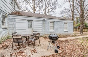 A house with a patio, a grill, and a table with chairs. - Haddington House (Memphis)