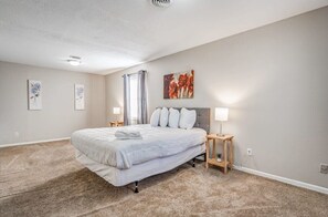 A bedroom with a large bed, two bedside tables, a ceiling light, and a window with curtains. - Warrington Nook (Memphis)