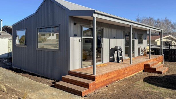 A modern single-story building with a covered porch, large windows, and a wooden deck. - Roto Cottage - Lake Tekapo (Lake Tekapo)