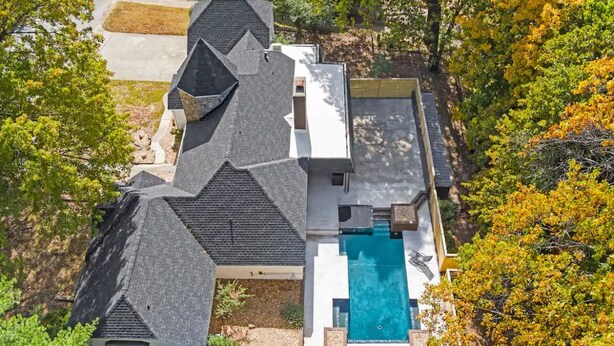 A house with a large swimming pool, surrounded by trees and a well-maintained lawn. - NWA Getaway Pool, Arcade, Trails (Springdale)