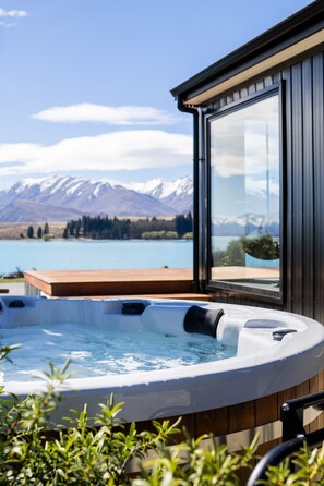 Ein Whirlpool mit Blick auf einen See und Berge.