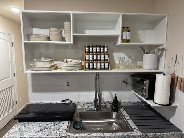 Fridge, microwave, coffee/tea maker, cookware/dishes/utensils