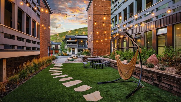 An outdoor patio area with a hammock, stone steps, and string lights. - Après All Day! 3B Walk to Lifts Firepit, Poker, Ski Room, Disco Balls, Views! (Park City)