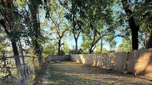 A paved pathway with a brick pattern, surrounded by trees and a wooden fence. - Hickory House - South Park near UD Campus, Miami Valley Hospital, & Downtown (Dayton)