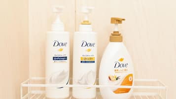 Three Dove personal care products on a white shelf.