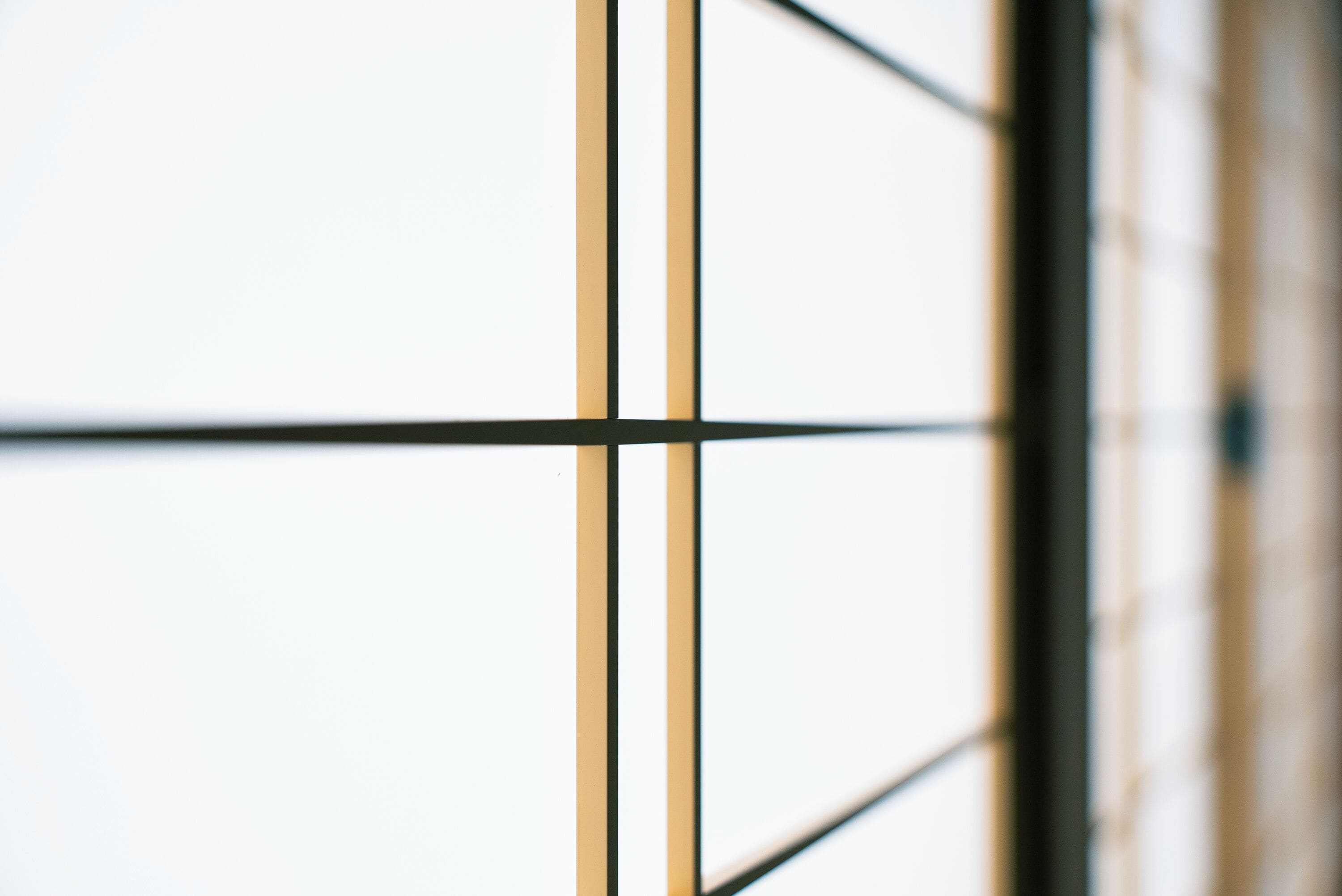 A close-up of a window with a grid pattern, likely part of a building's facade.
