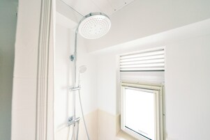 Family Apartment, City View | Bathroom | Shower, free toiletries, hair dryer, slippers