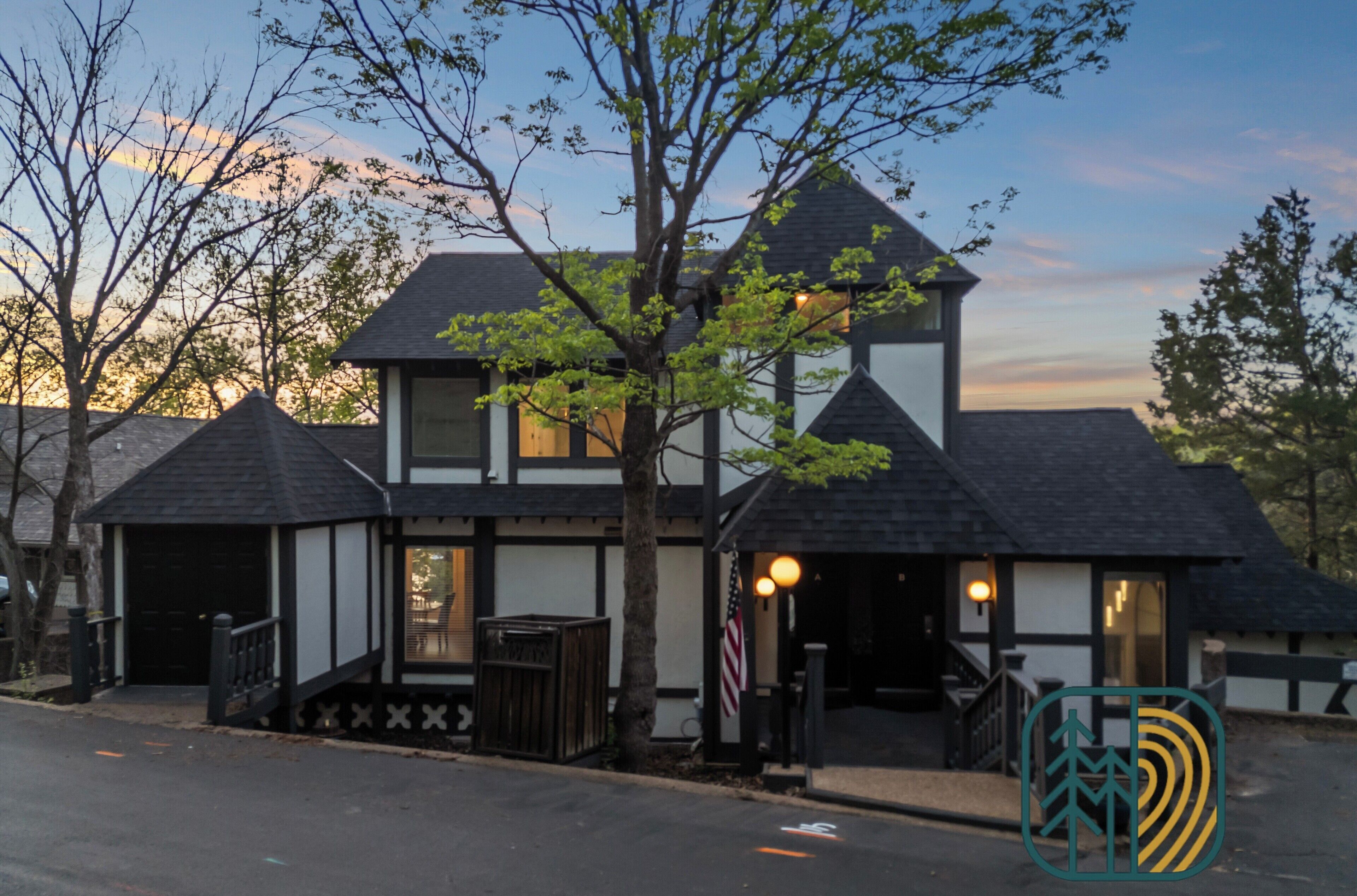 A traditional building with a symmetrical facade, a central entrance, and a small porch area.