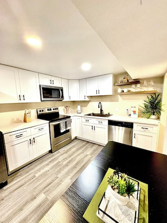 Fridge, microwave, oven, stovetop. Renovated Private Residence Below basement, Garage, EV charger, Fenced patio.
