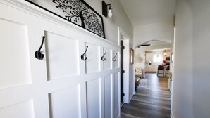 A hallway with white paneling and black door handles. - Welcoming updated modern 3-bedroom house in Mount Clemens (Mount Clemens)