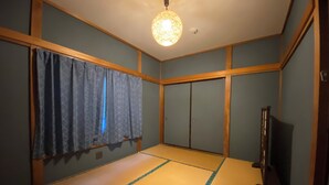 A room with tatami flooring, a ceiling light fixture, a television, and a sliding door. - TraditionalJapanese Vacation house near to metro station, 4 bedroom Multiple bath (墨田区)