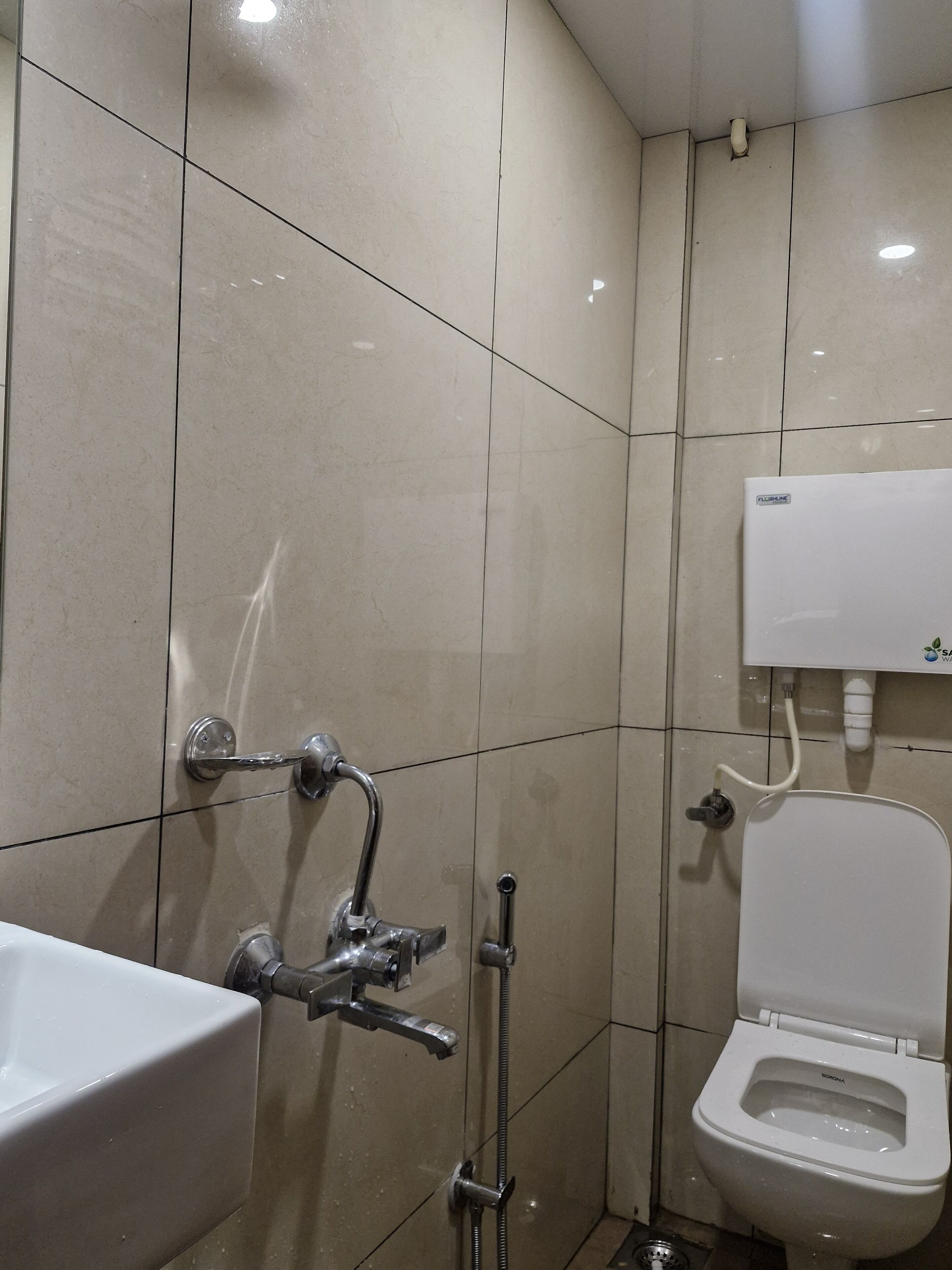 A bathroom with a toilet, a sink, and a shower.