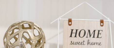 A decorative sphere and a wooden sign with 'HOME sweet home' text.