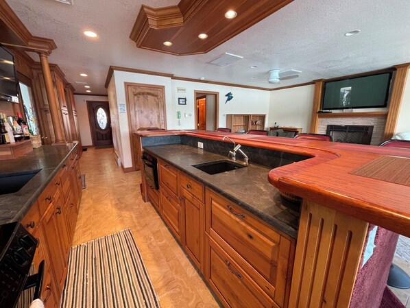 A kitchen with wooden cabinets, a granite countertop, and a built-in oven.