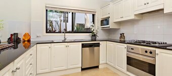 On little Austinmer beach encircled by resturants to surf,swim,fish, boat or ski