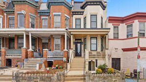 A row of Victorian-style townhouses with brick facades, multiple stories, and prominent gabled roofs. - DC Urban Retreat+3Bed+Newly Renovated (Washington)