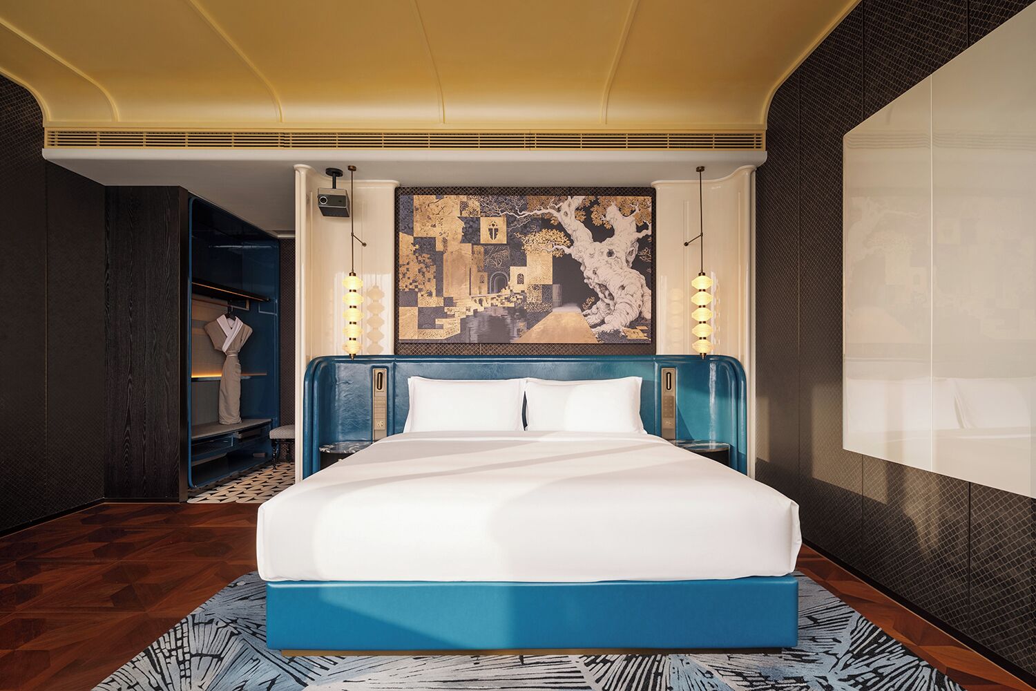 A modern hotel room with a large bed, a wardrobe, and a decorative wall piece.