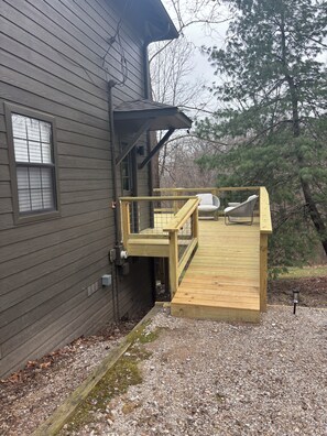 A house with a wooden deck, a window, and a door. - The Gravity Getaway, it's all downhill from here. (Bella Vista)