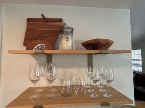 A wooden shelf with wine glasses and a candle. - The Gravity Getaway, it's all downhill from here. (Bella Vista)