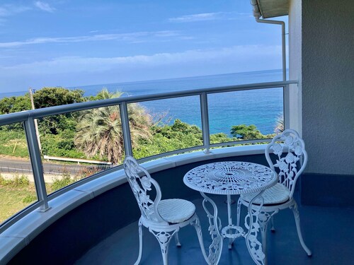 Luxrious double room with mountain view and ocean view from the balcony and an interior window / Hamada Shimane