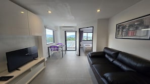 Apartment, Balcony, City View | Living area | Flat-screen TV