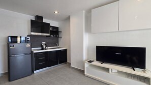 Departamento, balcón, vista a la ciudad | Cocina privada | Refrigerador, microondas, parrilla de estufa y utensilios de cocina 