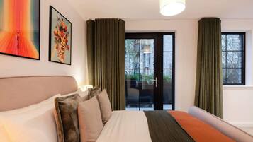 A hotel room with a bed, a large window, and a view of the outside.