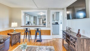 A living room with a wooden bench, a small table with a lamp, and a large mirror reflecting the kitchen. - < 1 Mi to Lake: Mtn-View Cabin w/ Porch in Newport (Newport)