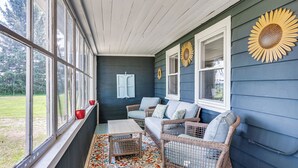 A porch with wicker furniture, a wooden table, and a colorful rug. - < 1 Mi to Lake: Mtn-View Cabin w/ Porch in Newport (Newport)