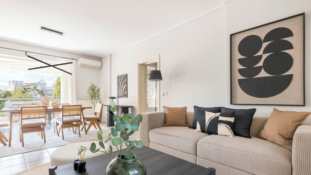 A modern living room with a sofa, coffee table, and a large abstract painting. - Family Escape in Chalandri -Parnassidos 10 (Chalandri)