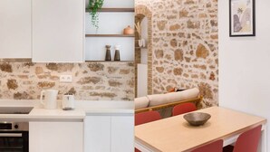 A modern kitchen with white cabinets, a built-in oven, and a countertop with a kettle and a mug. - Psyrri Hideout · Chic 2BR Apartment (Athina)