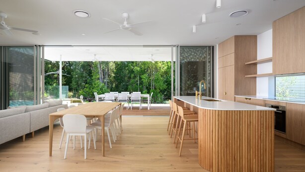 A modern kitchen with a central island, wooden cabinets, and a large window overlooking a garden. - Navy'S By The Beach - Rainbow Shores (Rainbow Beach)