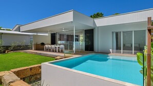 A modern house with a swimming pool, a covered patio, and a large sliding glass door. - Navy'S By The Beach - Rainbow Shores (Rainbow Beach)