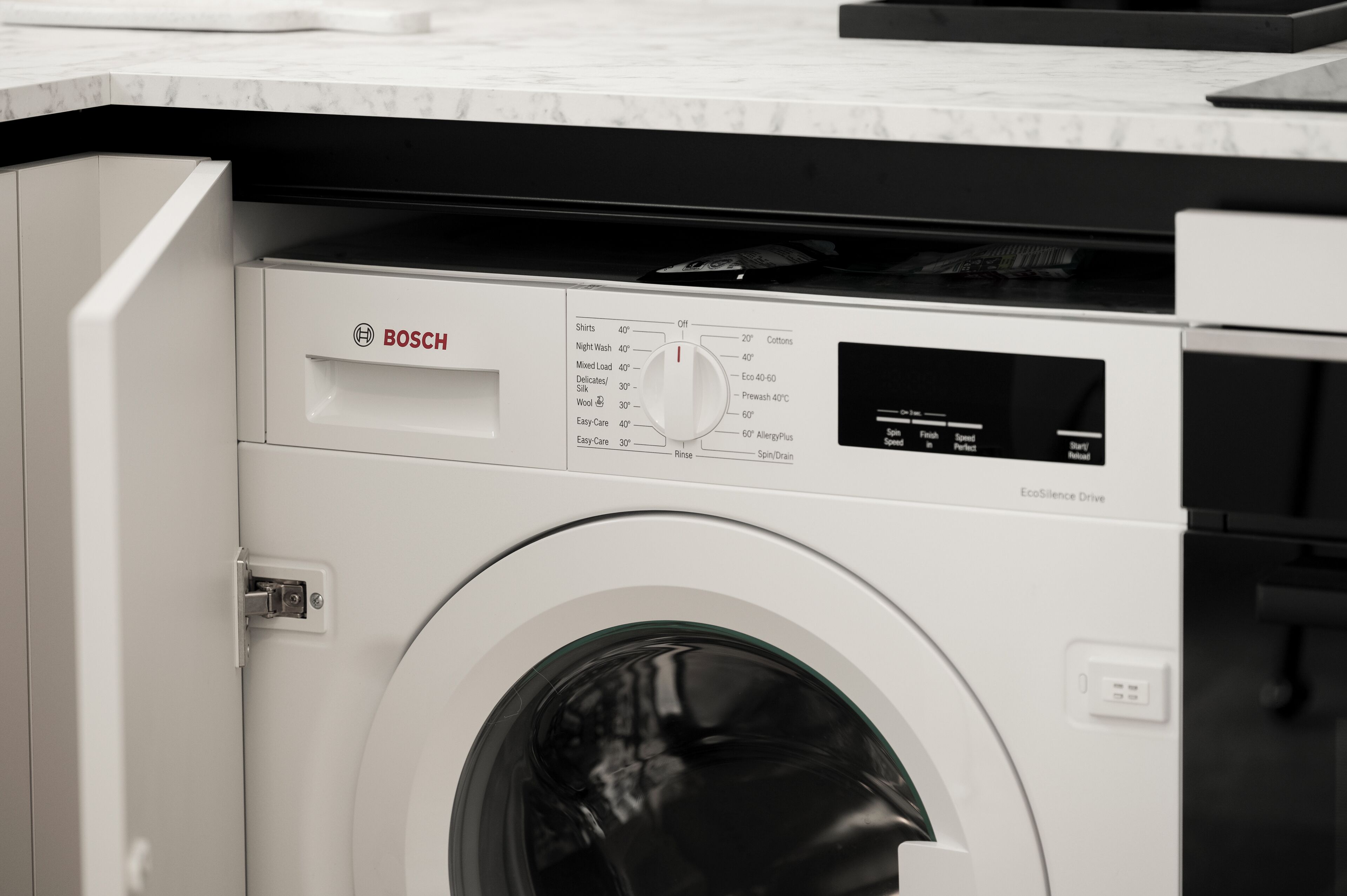 A Bosch washing machine with a control panel and a front-loading door.
