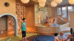 A children's play area with a slide, climbing net, and colorful balls. - Vinhomes Grand Park-Masterise Center (Ho Chi Minh City)