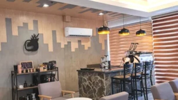 A modern interior with a bar area, seating, and a decorative wall. - Star Hotel Davao (Davao)