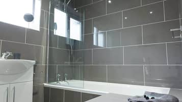 Shower, hair dryer, towels, shampoo