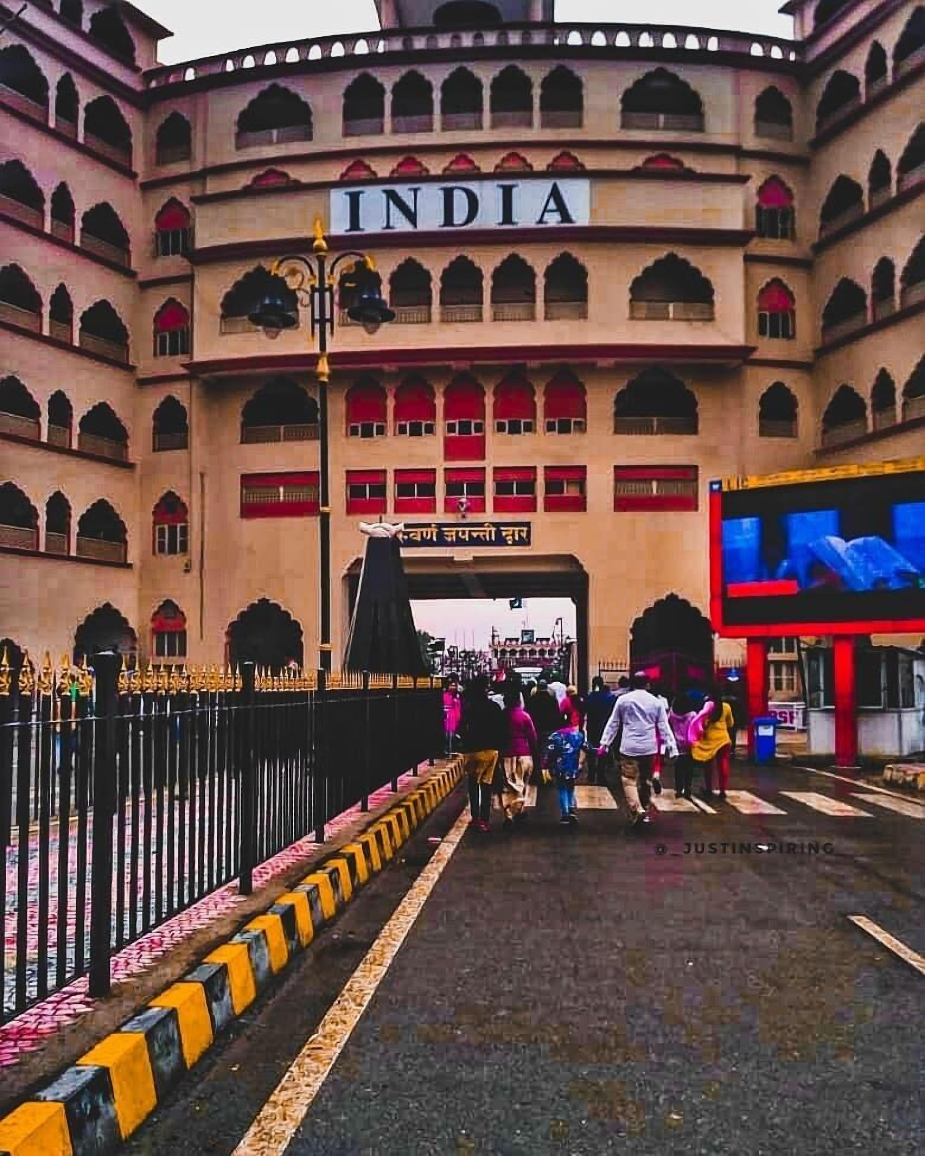 A large, historic building with the word "INDIA" prominently displayed at the entrance.