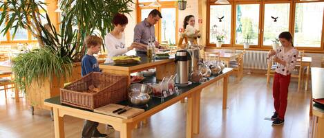 A café with a long wooden table, baskets, and various food items.