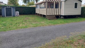 A mobile home with a porch and a garage.