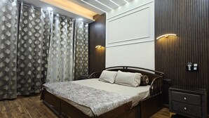 A bedroom with a wooden bed, a nightstand, and a wardrobe.