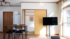 A compact living space with a dining area, a television, and a bed. - FURANO RELAX STAY BC (Furano)