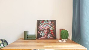 A painting on a wooden table with a green book and a green object beside it. - Green Lux-Via Canalino| Pass ZTL&Parking A/C WiFi (Modena)