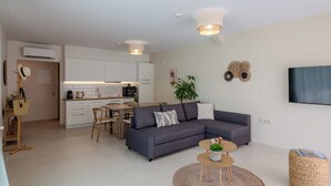 A modern apartment with a living room, kitchen, and dining area. - Alcyone - Gournes NewTown Residences (Heraklion)