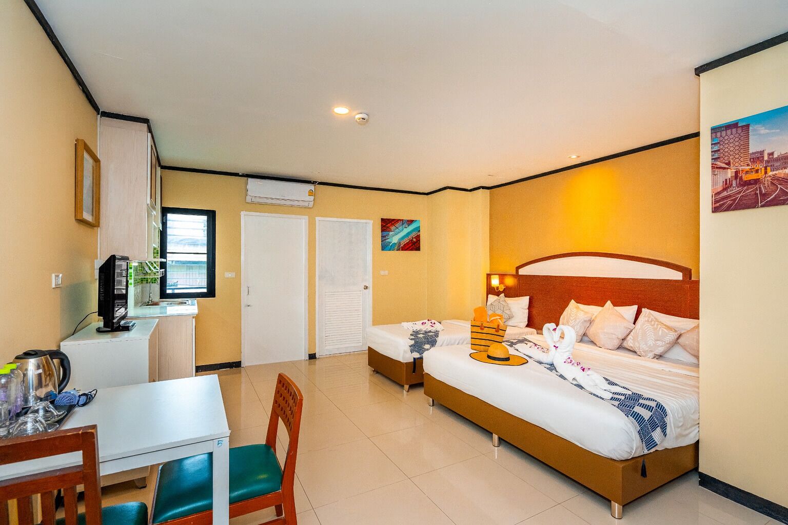 A hotel room with a bed, a desk, a chair, and a television.