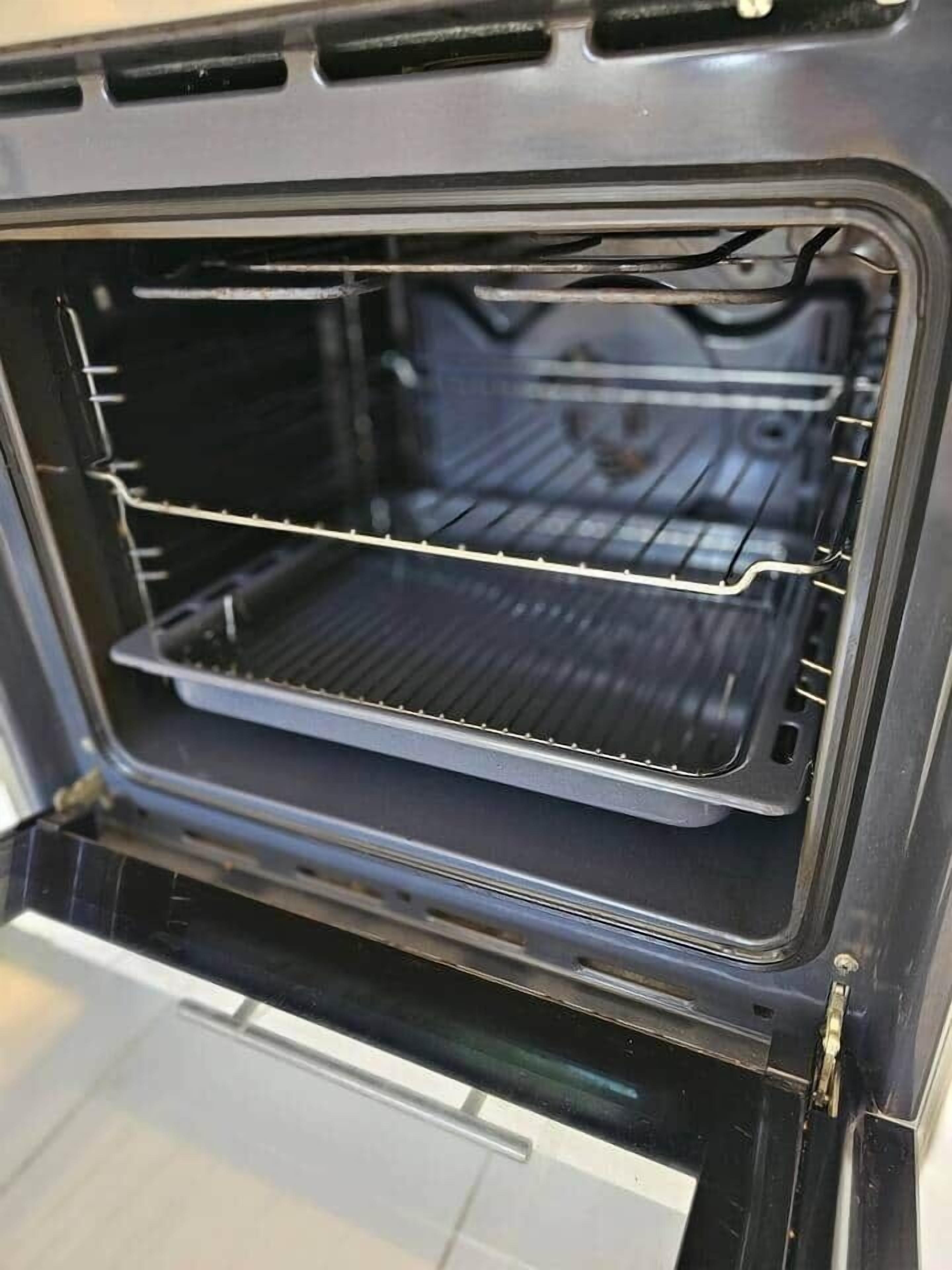 An empty oven with a metal rack inside.