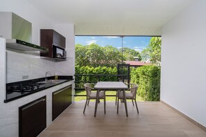 Deluxe Double Room, Garden View | Private kitchen | Fridge, microwave, stovetop, cookware/dishes/utensils - DC Residence Phuket (Chalong)