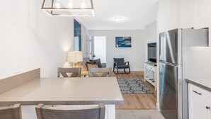 A modern kitchen with a central island, stainless steel appliances, and a pendant light. - Pet-Friendly, Stylish Home w/ Backyard Oasis (Santa Maria)