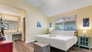 A bedroom with a bed, a vanity with a mirror, and a window with blinds. - Cozy North Austin Home | Pet-Friendly | Grill | Close to Shopping & Trails (Austin)