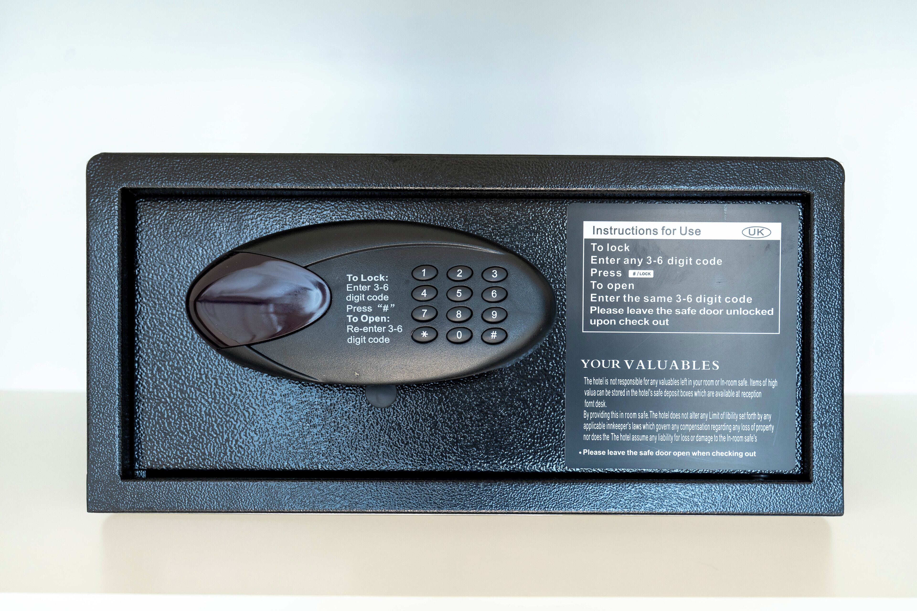 A digital safe with instructions for use, a keypad, and a lock mechanism.